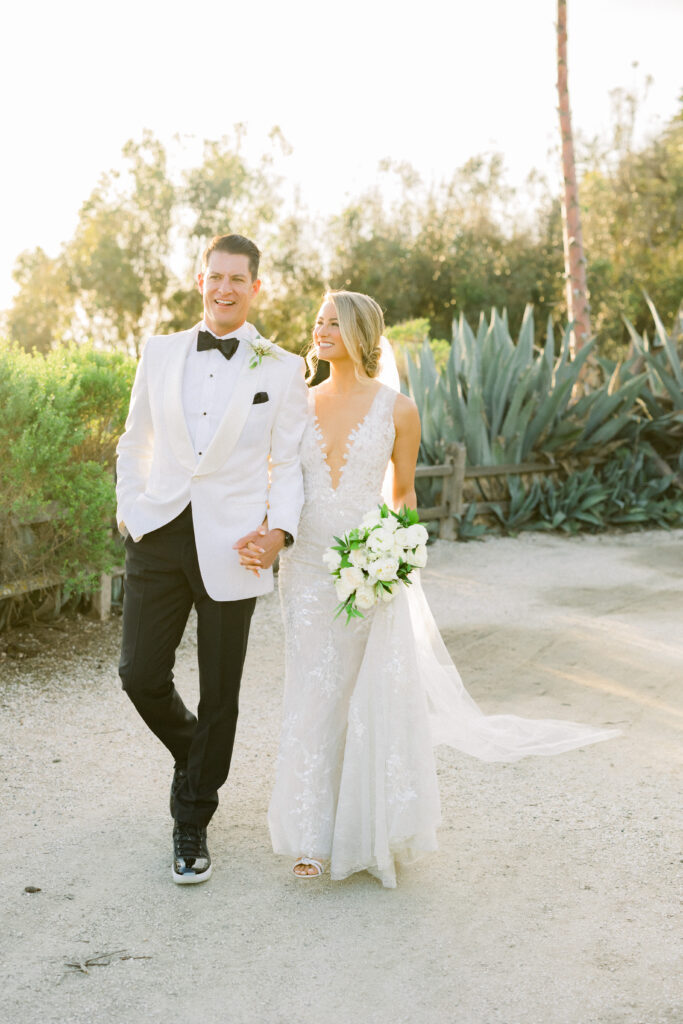 Bride and groom walk hand-in-hand at the Bacara