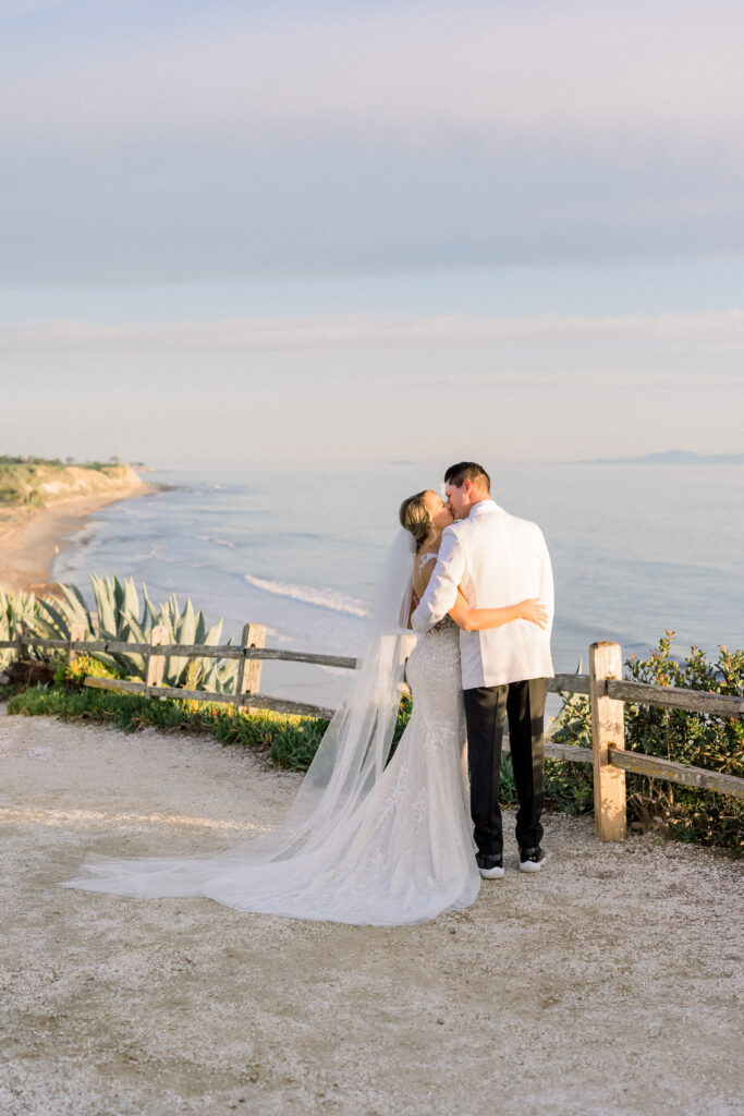 Bride and groom share a kiss during golden light photos on their wedding dat at the Bacara